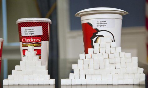 Soft drink cups sized (L-R) at 32 ounces and 64 ounces are displayed at a news conference at City Hall in New York, May 31, 2012. REUTERS/An Soft drink cups sized (L-R) at 32 ounces and 64 ounces are displayed at a news conference at City Hall in New York, May 31, 2012. REUTERS/An
