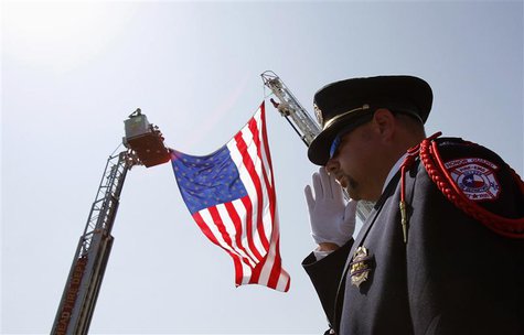 Killeen, Texas, fire-fighter Charles Layton salutes a procession of vehicles in honor of fallen fire-fighter Captain Kenneth "Luckey" Harris Killeen, Texas, fire-fighter Charles Layton salutes a procession of vehicles in honor of fallen fire-fighter Captain Kenneth "Luckey" Harris