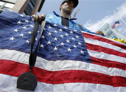 A Boston Marathon runner stands with his medal, which he dyed black, outside the Cathedral of the Holy Cross where United States President Barack Obama attended an interfaith service for the victims of the Boston Marathon bombings in Boston, Massachusetts April 18, 2013.
Credit: Reuters/Jessica Rinaldi
A Boston Marathon runner stands with his medal, which he dyed black, outside the Cathedral of the Holy Cross where United States President Barack Obama attended an interfaith service for the victims of the Boston Marathon bombings in Boston, Massachusetts April 18, 2013.
Credit: Reuters/Jessica Rinaldi