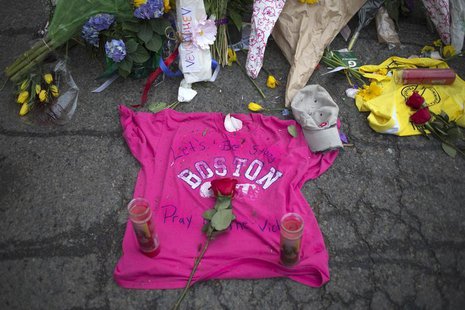 Well-wishers leave a shirt at a make-shift memorial on Boylston Street a day after two explosions hit the Boston Marathon in Boston, Massach Well-wishers leave a shirt at a make-shift memorial on Boylston Street a day after two explosions hit the Boston Marathon in Boston, Massach