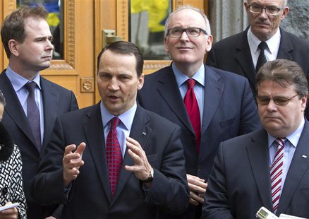 Poland's Foreign Minister Radoslaw Sikorski (2nd L), Lithuanian Foreign Minister Linas Linkevicius (R), Dutch Foreign Minister Frans Timmerm Poland's Foreign Minister Radoslaw Sikorski (2nd L), Lithuanian Foreign Minister Linas Linkevicius (R), Dutch Foreign Minister Frans Timmerm