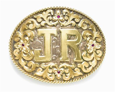 A ruby-adorned silver and gold belt buckle from the U.S. television drama "Dallas" owned by the late actor Larry Hagman is shown in this pub A ruby-adorned silver and gold belt buckle from the U.S. television drama "Dallas" owned by the late actor Larry Hagman is shown in this pub