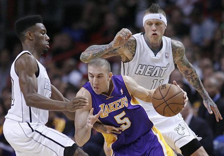 Miami Heat's Norris Cole (L) defends against Los Angeles Lakers' Steve Blake (C) as Heat teammate Chris Andersen (R) looks on in the first h Miami Heat's Norris Cole (L) defends against Los Angeles Lakers' Steve Blake (C) as Heat teammate Chris Andersen (R) looks on in the first h