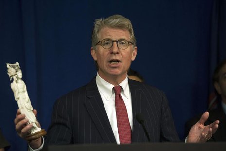 New York's District Attorney Cyrus Vance holds up an ivory carving figurine during a news conference to announce the guilty pleas of two ivo New York's District Attorney Cyrus Vance holds up an ivory carving figurine during a news conference to announce the guilty pleas of two ivo