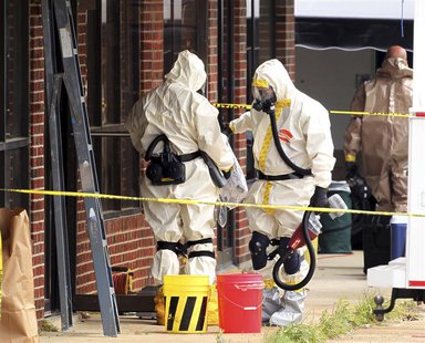 Hazmat officers enter a taekwondo studio previously operated by James Everett Dutschke in Tupelo, Mississippi April 24, 2013. REUTERS/Lauren Hazmat officers enter a taekwondo studio previously operated by James Everett Dutschke in Tupelo, Mississippi April 24, 2013. REUTERS/Lauren