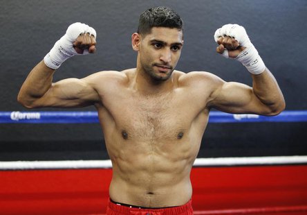 British boxer Amir Khan poses during a media opportunity at Ponce De Leon Boxing Club in Montebello, California December 11, 2012, for his u British boxer Amir Khan poses during a media opportunity at Ponce De Leon Boxing Club in Montebello, California December 11, 2012, for his u