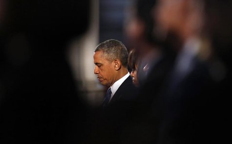 U.S. President Barack Obama and first lady Michelle Obama pray during an interfaith memorial service at the Cathedral of the Holy Cross for U.S. President Barack Obama and first lady Michelle Obama pray during an interfaith memorial service at the Cathedral of the Holy Cross for