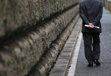 A man walks beside the Bank of Japan (BOJ) building in Tokyo November 19, 2012. REUTERS/Toru Hanai A man walks beside the Bank of Japan (BOJ) building in Tokyo November 19, 2012. REUTERS/Toru Hanai