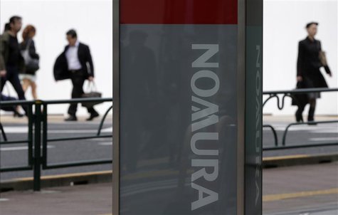 People walk behind a signboard of Nomura Securities outside its branch in Tokyo April 25, 2013. REUTERS/Toru Hanai People walk behind a signboard of Nomura Securities outside its branch in Tokyo April 25, 2013. REUTERS/Toru Hanai