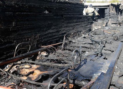Russian emergency service staff work at the site of a fire at a psychiatric hospital in the village of Ramensky, north of Moscow April 26, 2 Russian emergency service staff work at the site of a fire at a psychiatric hospital in the village of Ramensky, north of Moscow April 26, 2