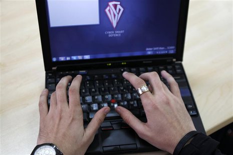Romanian Razvan Cernaianu, formerly known as a hacker by the name of TinKode, works at his laptop in his office in Bucharest in this March 1 Romanian Razvan Cernaianu, formerly known as a hacker by the name of TinKode, works at his laptop in his office in Bucharest in this March 1