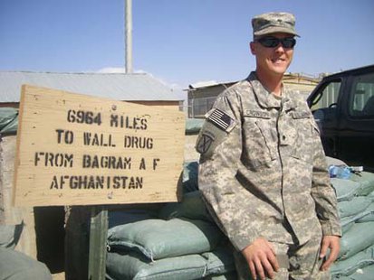 A member of the South Dakota National Guard stands near a Wall Drug sign in Afghanistan - Public domain photo A member of the South Dakota National Guard stands near a Wall Drug sign in Afghanistan - Public domain photo