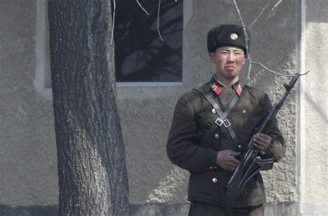 A North Korean soldier stands on the bank of Yalu River, near the North Korean town of Sinuiju, opposite the Chinese border city of Dandong, A North Korean soldier stands on the bank of Yalu River, near the North Korean town of Sinuiju, opposite the Chinese border city of Dandong,