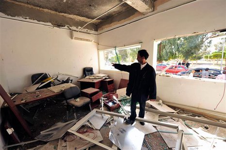 A policeman stands inside an office of a police station after a bomb explosion in Benghazi, April 27, 2013. REUTERS/Esam Al-Fetori A policeman stands inside an office of a police station after a bomb explosion in Benghazi, April 27, 2013. REUTERS/Esam Al-Fetori