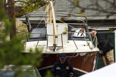 Members of the FBI Evidence Recovery Team inspect the boat where Boston Marathon bombing suspect Dzhokhar Tsarnaev was hiding at 67 Franklin Members of the FBI Evidence Recovery Team inspect the boat where Boston Marathon bombing suspect Dzhokhar Tsarnaev was hiding at 67 Franklin