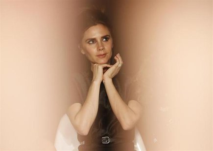 Designer and former Spice Girl Victoria Beckham is seen between models while judging the Woolmark Prize during London Fashion Week, February Designer and former Spice Girl Victoria Beckham is seen between models while judging the Woolmark Prize during London Fashion Week, February