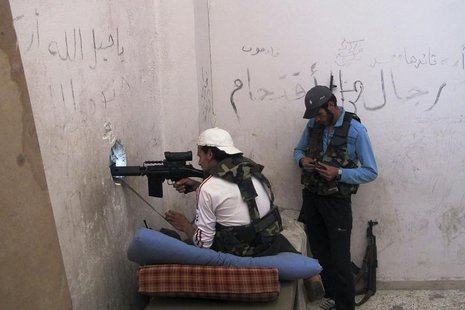 A Free Syrian Army fighter takes up firing position in the Khan al-Assal area, near Aleppo April 27, 2013. REUTERS/Abdalghne Karoof A Free Syrian Army fighter takes up firing position in the Khan al-Assal area, near Aleppo April 27, 2013. REUTERS/Abdalghne Karoof