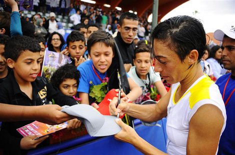 Francesca Schiavone of Italy signs autographs for fans after defeating Lourdes Dominguez Lino of Spain in their women's singles final tennis Francesca Schiavone of Italy signs autographs for fans after defeating Lourdes Dominguez Lino of Spain in their women's singles final tennis