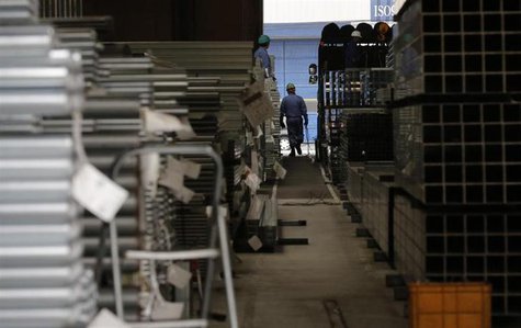 A worker walks at a factory in Urayasu, near Tokyo March 29, 2013. REUTERS/Toru Hanai A worker walks at a factory in Urayasu, near Tokyo March 29, 2013. REUTERS/Toru Hanai