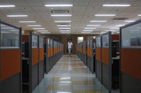 An employee arrives at Tech Mahindra office building in Noida on the outskirts of New Delhi March 18, 2013. REUTERS/Adnan Abidi An employee arrives at Tech Mahindra office building in Noida on the outskirts of New Delhi March 18, 2013. REUTERS/Adnan Abidi