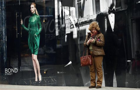 A woman looks at her mobile phone as she stands on New Bond Street in London April 19, 2013. REUTERS/Suzanne Plunkett A woman looks at her mobile phone as she stands on New Bond Street in London April 19, 2013. REUTERS/Suzanne Plunkett