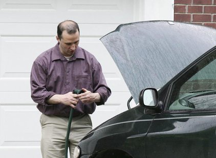 Everett Dutschke works on his mini-van in his driveway in Tupelo Mississippi on April 26, 2013. Federal agents arrested Dutschke on Saturday Everett Dutschke works on his mini-van in his driveway in Tupelo Mississippi on April 26, 2013. Federal agents arrested Dutschke on Saturday