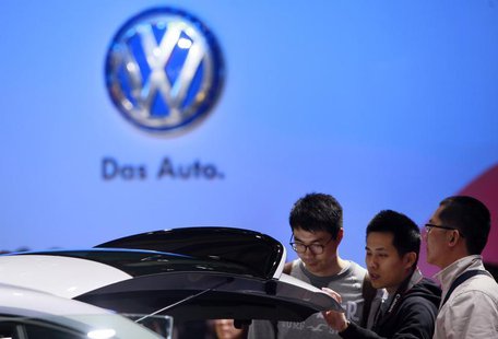 Guests look at a Volkswagen car during the media day at 15th Shanghai International Automobile Industry Exhibition in Shanghai April 20, 201 Guests look at a Volkswagen car during the media day at 15th Shanghai International Automobile Industry Exhibition in Shanghai April 20, 201