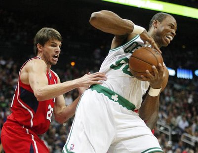 Boston Celtics center Jason Collins (R), grabs a rebound away from Atlanta Hawks guard Kyle Korver in the first half of their NBA basketball Boston Celtics center Jason Collins (R), grabs a rebound away from Atlanta Hawks guard Kyle Korver in the first half of their NBA basketball