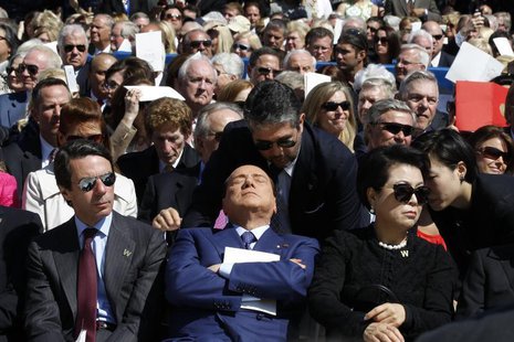 Former Italian Prime Minister Silvio Berlusconi (C ) is pictured as a translator repeats remarks by former U.S. president George W. Bush (no Former Italian Prime Minister Silvio Berlusconi (C ) is pictured as a translator repeats remarks by former U.S. president George W. Bush (no