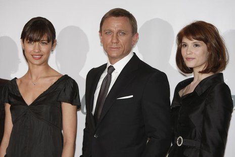Actress Gemma Arterton (R) who plays Agent Fields, actor Daniel Craig who plays James Bond and actress Olga Kurylenko who plays Camille pose Actress Gemma Arterton (R) who plays Agent Fields, actor Daniel Craig who plays James Bond and actress Olga Kurylenko who plays Camille pose