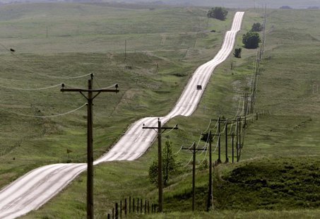 A lone vehicle travels one of the many monotonous roads on the Pine Ridge Indian Reservation in South Dakota. REUTERS/ANDY CLARK A lone vehicle travels one of the many monotonous roads on the Pine Ridge Indian Reservation in South Dakota. REUTERS/ANDY CLARK