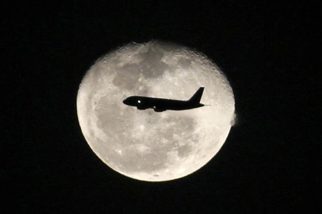 A passenger jet flies in front of the moon in Bogota November 1,2012. REUTERS/Felipe Caicedo A passenger jet flies in front of the moon in Bogota November 1,2012. REUTERS/Felipe Caicedo