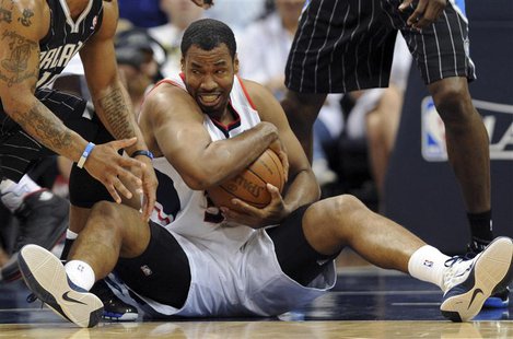Atlanta Hawks center Jason Collins controls the ball during an NBA Eastern Conference Game 6 playoff against the Orlando Magic in Atlanta, G Atlanta Hawks center Jason Collins controls the ball during an NBA Eastern Conference Game 6 playoff against the Orlando Magic in Atlanta, G