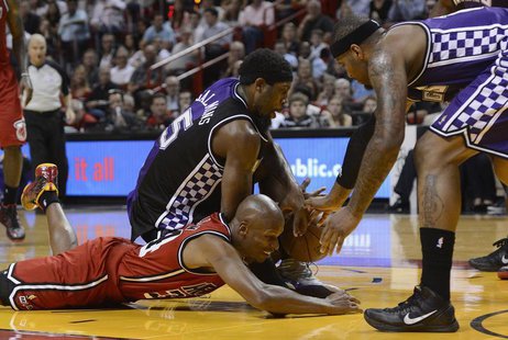 Miami Heat's Ray Allen (L) scrambles for a loose ball with Sacramento Kings' John Salmons (C) and DeMarcus Cousins (R) during the first half Miami Heat's Ray Allen (L) scrambles for a loose ball with Sacramento Kings' John Salmons (C) and DeMarcus Cousins (R) during the first half
