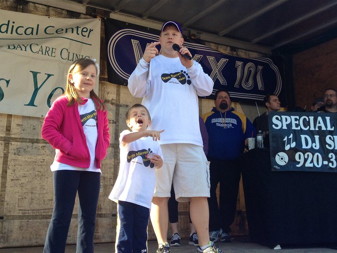 March of Dimes Advocate and one of the March's coordinator Andy Van Remortel and family address the crowd