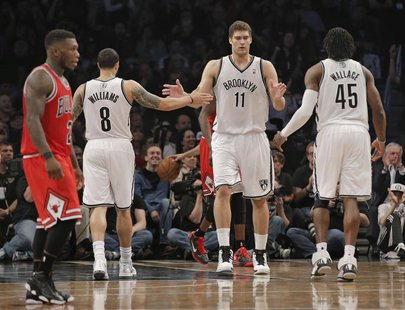 Brooklyn Nets guard Deron Williams (8), center Brook Lopez (11) and forward Gerald Wallace (45) tap hands as Chicago Bulls point guard Nate Brooklyn Nets guard Deron Williams (8), center Brook Lopez (11) and forward Gerald Wallace (45) tap hands as Chicago Bulls point guard Nate
