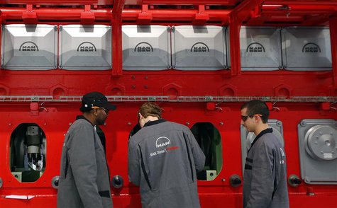 Workers assemble a large Diesel engine at the MAN Diesel & Turbo factory in Augsburg March 6, 2013. MAN Diesel & Turbo, a a company within t Workers assemble a large Diesel engine at the MAN Diesel & Turbo factory in Augsburg March 6, 2013. MAN Diesel & Turbo, a a company within t