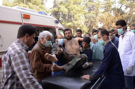 Residents and medics transport a Syrian Army soldier, wounded in what they said was a chemical weapon attack near Aleppo, to a hospital Marc Residents and medics transport a Syrian Army soldier, wounded in what they said was a chemical weapon attack near Aleppo, to a hospital Marc