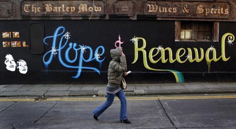 A woman walks past graffiti on the side of a building in Dublin December 5, 2011. REUTERS/Cathal McNaughton A woman walks past graffiti on the side of a building in Dublin December 5, 2011. REUTERS/Cathal McNaughton