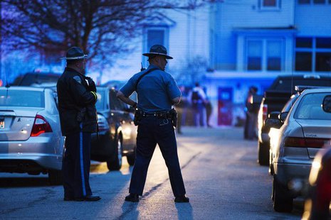 Law enforcement officials stand at the scene on Franklin St. as the search for Dzhokhar Tsarnaev, the surviving suspect in the Boston Marath Law enforcement officials stand at the scene on Franklin St. as the search for Dzhokhar Tsarnaev, the surviving suspect in the Boston Marath