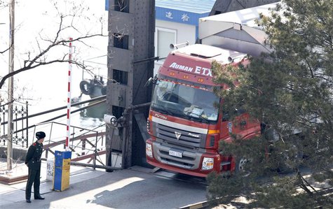 A Chinese paramilitary policeman stands guard as a truck with a North Korea license plate drives on the Friendship Bridge over the Yalu Rive A Chinese paramilitary policeman stands guard as a truck with a North Korea license plate drives on the Friendship Bridge over the Yalu Rive