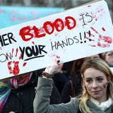 A woman holds a poster during a vigil in Dublin November 17, 2012, in memory of Savita Halappanavar and in support of changes to abortion la