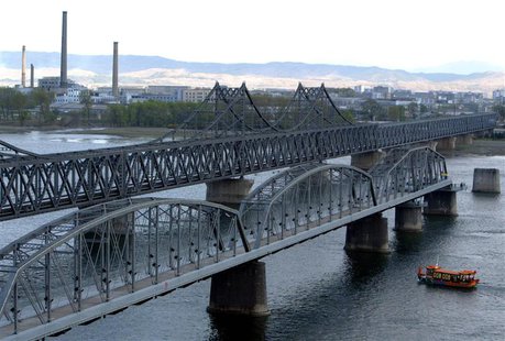 A boat passes beneath the "Broken Bridge" between China and North Korea in Dandong, Liaoning province in this April 23, 2004 file picture. R A boat passes beneath the "Broken Bridge" between China and North Korea in Dandong, Liaoning province in this April 23, 2004 file picture. R