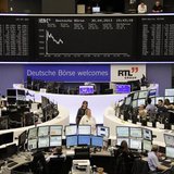 Traders work at their desks in front of the DAX board at the Frankfurt stock exchange April 30, 2013. REUTERS/Remote/Marte Kiessling