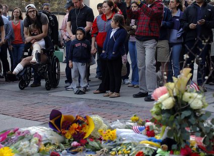 A Boston Marathon bombing survivor (L) visits the site of the first bomb explosion on Boylston Street in Boston, Massachusetts April 24, 201 A Boston Marathon bombing survivor (L) visits the site of the first bomb explosion on Boylston Street in Boston, Massachusetts April 24, 201