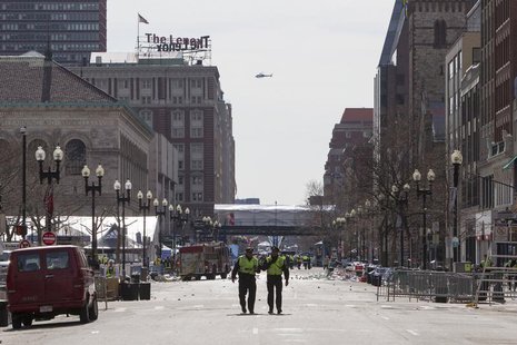 Boston police officers patrol down Boylston Street near the scene of multiple explosions near the end of the Boston Marathon finish line in Boston police officers patrol down Boylston Street near the scene of multiple explosions near the end of the Boston Marathon finish line in