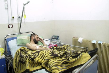 A wounded Syrian refugee who activists said was injured during shelling by forces loyal to Syrian President Bashar al-Assad, lies in a hospi A wounded Syrian refugee who activists said was injured during shelling by forces loyal to Syrian President Bashar al-Assad, lies in a hospi