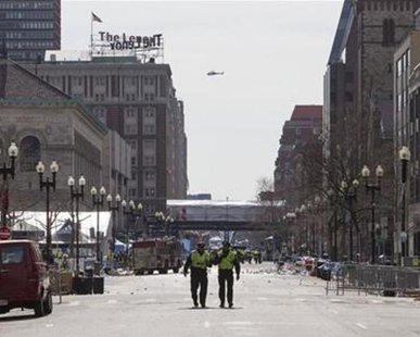 Boston police officers patrol down Boylston Street near the scene of multiple explosions near the end of the Boston Marathon finish line in Boston, Massachusetts April 15, 2013. REUTERS/Scott Eisen Boston police officers patrol down Boylston Street near the scene of multiple explosions near the end of the Boston Marathon finish line in Boston, Massachusetts April 15, 2013. REUTERS/Scott Eisen