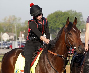 Exercise rider Jenn Patterson gives Kentucky Derby hopeful Orb a pat before galloping on the track during morning workouts at Churchill Down Exercise rider Jenn Patterson gives Kentucky Derby hopeful Orb a pat before galloping on the track during morning workouts at Churchill Down