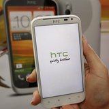 A salesperson shows an HTC Sensation XL smartphone in a mobile phone shop in Taipei April 8, 2013. REUTERS/Pichi Chuang